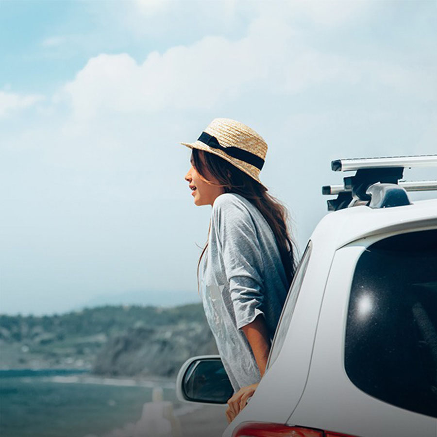 woman in a car looking at the sea